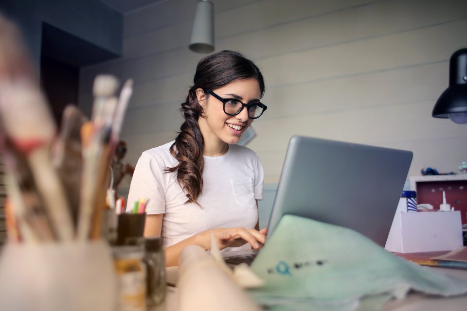 Job seeker updating her resume on a laptop